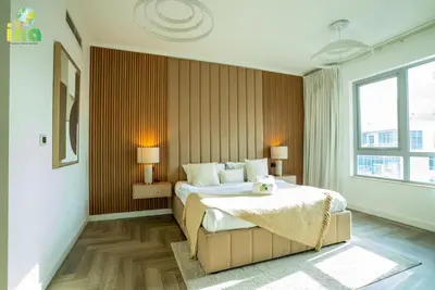 a bedroom with a bed and a large window at INA HOMES - Luxury 2 Bedroom Apartment with Full Burj Khalifa & Fountain Views in Dubai