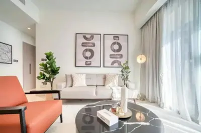 a living room with a couch and a table at Oshima Act Two Downtown 1BR Burj Khalifa in Dubai