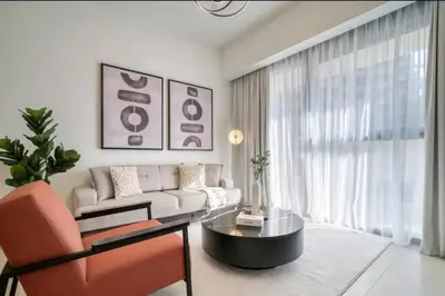 a living room with a couch and a table at Oshima Act Two Downtown 1BR Burj Khalifa in Dubai