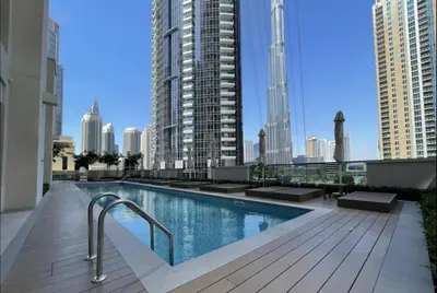 a swimming pool on the roof of a building with tall buildings at Oshima Act Two Downtown 1BR Burj Khalifa in Dubai
