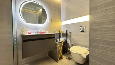 a bathroom with a sink and a toilet and a mirror at Studio in central location with Balcony nearby Metro in Dubai
