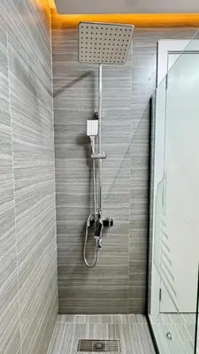 a shower with a shower head in a bathroom at Studio centrally located with a huge private balcony in Dubai
