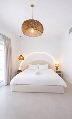 a white bedroom with a white bed and two lights at Dubai Escape Private Pool and Parking in Dubai
