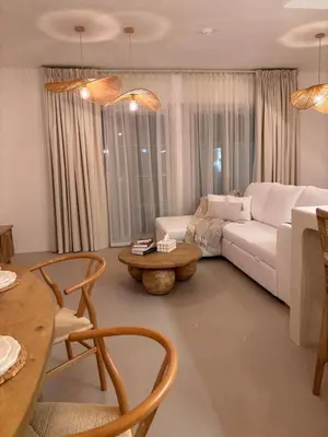 a living room with a white couch and a table at Dubai Escape Private Pool and Parking in Dubai