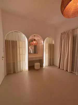 a room with two arched windows and a mirror at Dubai Escape Private Pool and Parking in Dubai