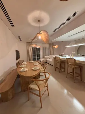 a kitchen and living room with a table and chairs at Dubai Escape Private Pool and Parking in Dubai