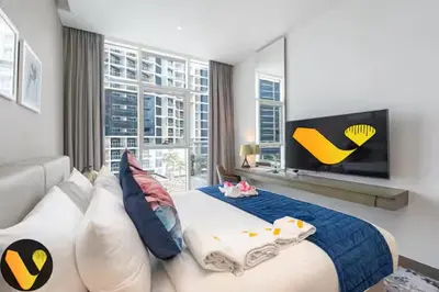 a bedroom with a large bed and a large window at Vogue Business Bay Damac Maison Prive near Burj Khalifa and Dubai Mall, Studio Apartment with Balcony, Pool and City View, Access to all Amenities in Dubai