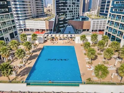 an overhead view of a swimming pool in a city at Vogue Business Bay Damac Maison Prive near Burj Khalifa and Dubai Mall, Studio Apartment with Balcony, Pool and City View, Access to all Amenities in Dubai