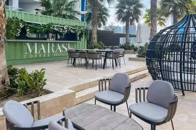 a group of chairs and tables in front of a restaurant at Vogue Business Bay Damac Maison Prive near Burj Khalifa and Dubai Mall, Studio Apartment with Balcony, Pool and City View, Access to all Amenities in Dubai