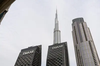 two skyscrapers with the burj khalifa in the background at Werova - Luxury 2BR Apartment w Breathtaking View in Dubai