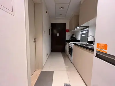 a kitchen with white cabinets and a black door at Modern 1BR Apartment Golf View Gym Pool in Dubai