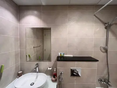 a bathroom with a sink and a shower at Modern 1BR Apartment Golf View Gym Pool in Dubai