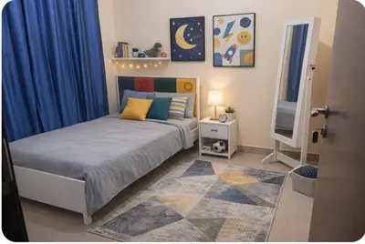 a bedroom with a bed with blue curtains and a rug at Luxury Entire 3 bed rooms with 3 bathrooms in Dubai