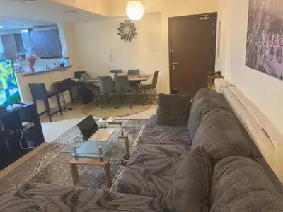 a living room with a couch and a table at Luxury Entire 3 bed rooms with 3 bathrooms in Dubai