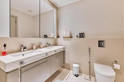a white bathroom with a sink and a toilet at PS5- Designer 2BR with Private Beach, Dubai Eye, Palm in Dubai