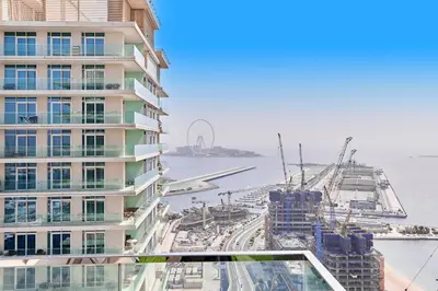 a view of a tall building and the water at PS5- Designer 2BR with Private Beach, Dubai Eye, Palm in Dubai