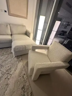 a living room with a couch and a chair at Oshima LIV Marina 1BR Marina View in Dubai