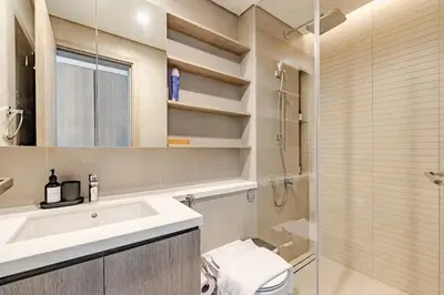 a bathroom with a sink and a toilet and a shower at Oshima LIV Marina 1BR Marina View in Dubai