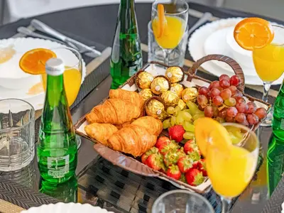 a table topped with a tray of food and fruit at Sky-high 1Br Apartment Sleeps 4 in Damac Paramount in Dubai