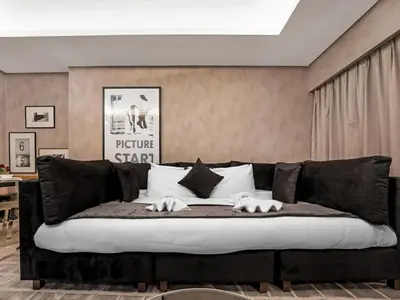 a black and white couch in a living room at Sky-high 1Br Apartment Sleeps 4 in Damac Paramount in Dubai
