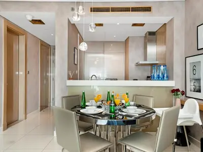 a dining room with a black table and chairs at Sky-high 1Br Apartment Sleeps 4 in Damac Paramount in Dubai