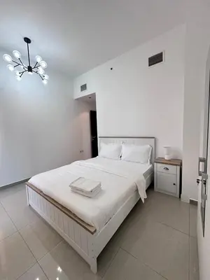 a white bedroom with a large white bed in a room at Marina Beach JBR 1BR Apartment in Dubai Marina in Dubai