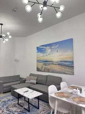 a living room with a couch and a table at Marina Beach JBR 1BR Apartment in Dubai Marina in Dubai