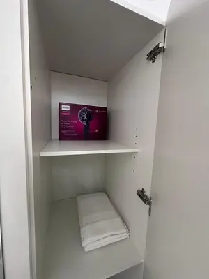 a small closet with a shelf with towels in it at Marina Beach JBR 1BR Apartment in Dubai Marina in Dubai