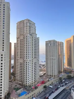 an aerial view of a city with tall buildings at Marina Beach JBR 1BR Apartment in Dubai Marina in Dubai