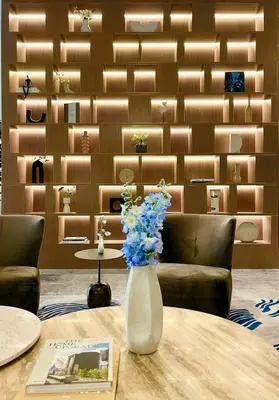 a vase with flowers on a table in a room at Downtown Suite Trendy 1BR -Dubai Mall Access in Dubai