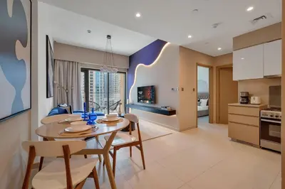 a kitchen and dining room with a table and chairs at Downtown Suite Trendy 1BR -Dubai Mall Access in Dubai