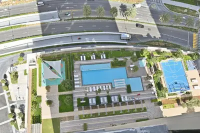 an aerial view of a building with a pool at Creek Rise Tower 2 - 1BR with Creek Views, Panoramic Living, Dubai Creek Harbour in Dubai