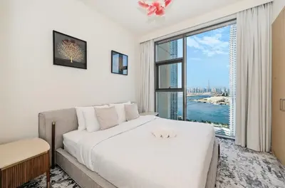 a bedroom with a large bed and a large window at Creek Rise Tower 2 - 1BR with Creek Views, Panoramic Living, Dubai Creek Harbour in Dubai