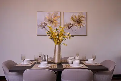 a dining room table with a vase with flowers on it at JBR 2BR with Iconic Palm Views Sadaf 6 Luxury in Dubai