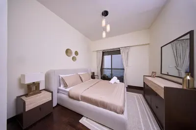 a bedroom with a large bed and a mirror at JBR 2BR with Iconic Palm Views Sadaf 6 Luxury in Dubai