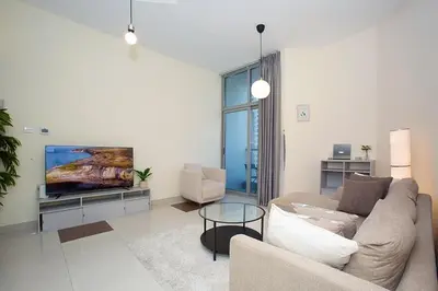 a living room with a couch and a tv at 2 Bedroom Apartment JBR Skyline with Balcony in Dubai