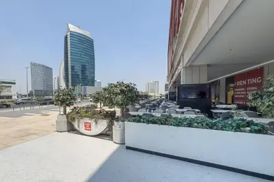 a view of a building with tables and chairs at Vogue Downtown Mag 318 near Burj Khalifa and Dubai Mall, Studio Apartment with Balcony, Pool and City View, Access to all Amenities in Dubai