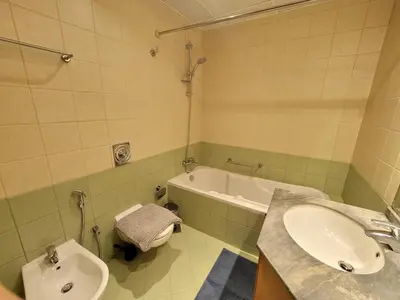 a bathroom with a sink and a tub and a toilet at One Bedroom Apartment in Mag 214, JLT in Dubai