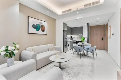 a living room with a couch and a table at Luxury 1 Bed Retreat with Balcony in JVT in Dubai