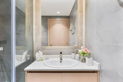 a bathroom with a sink and a shower at Luxury 1 Bed Retreat with Balcony in JVT in Dubai