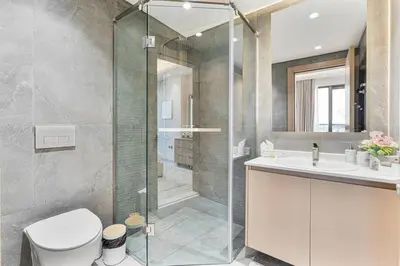 a bathroom with a shower and a toilet and a sink at Luxury 1 Bed Retreat with Balcony in JVT in Dubai