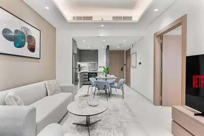 a living room with a couch and a table at Luxury 1 Bed Retreat with Balcony in JVT in Dubai