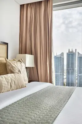 a bedroom with a bed and a large window at Frank Porter - Dubai Marina Mall Hotel in Dubai