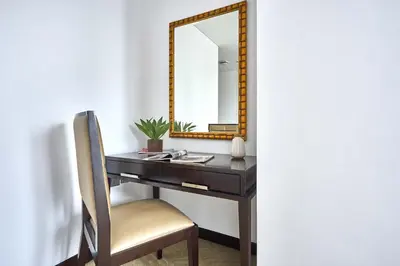 a desk with a mirror and a chair at Frank Porter - Dubai Marina Mall Hotel in Dubai