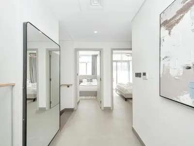 a hallway with white walls and a mirror at Royal Vista 26 - 4BR Villa at Arabian Ranches III in Nadd Shubayḩ