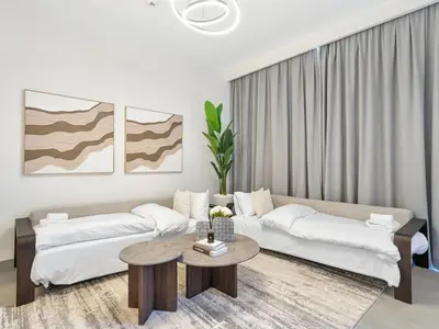 a living room with a couch and a table at Royal Vista 26 - 4BR Villa at Arabian Ranches III in Nadd Shubayḩ