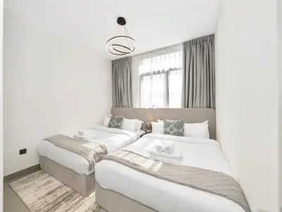 a bedroom with two beds and a window at Royal Vista 26 - 4BR Villa at Arabian Ranches III in Nadd Shubayḩ