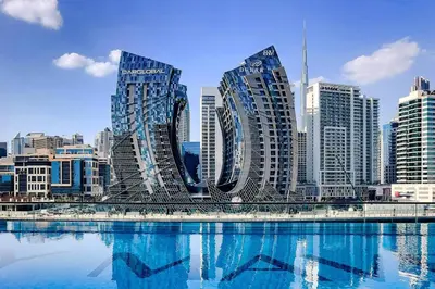 a city with tall buildings and a body of water at Luxury 1BR Duplex on the Canal Business Bay in Dubai