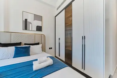 a bedroom with a bed and a closet at Elegant 2BR Retreat at Opalz Arjan in Dubai