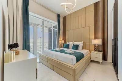 a bedroom with a bed and a large window at Elegant 2BR Retreat at Opalz Arjan in Dubai